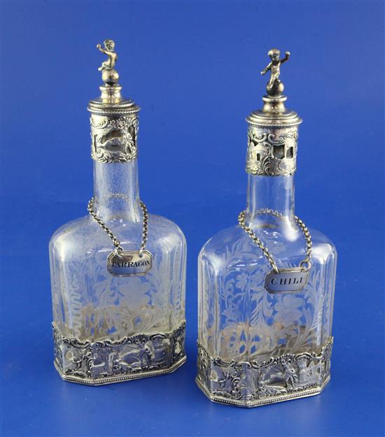 A pair of late 19th/early 20th century continental silver mounted etched scent flasks with figural stoppers & two wine labels.